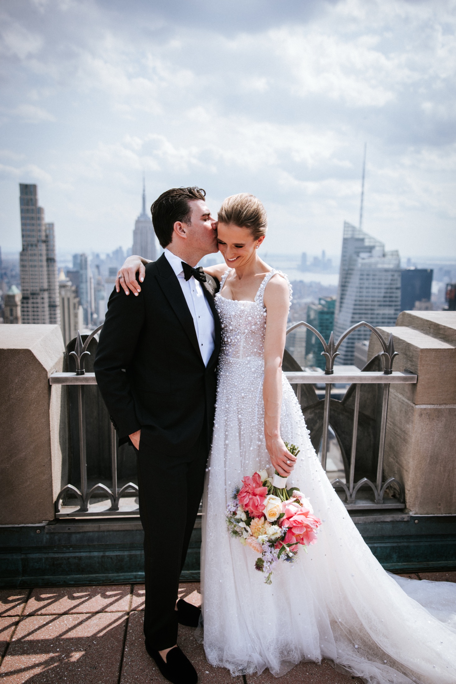 Couple embracing above the Manhattan skyline at 620 Loft and Garden
